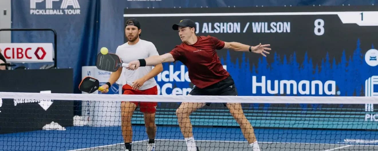 Christian Alshon hits a forehand volley in pickleball.