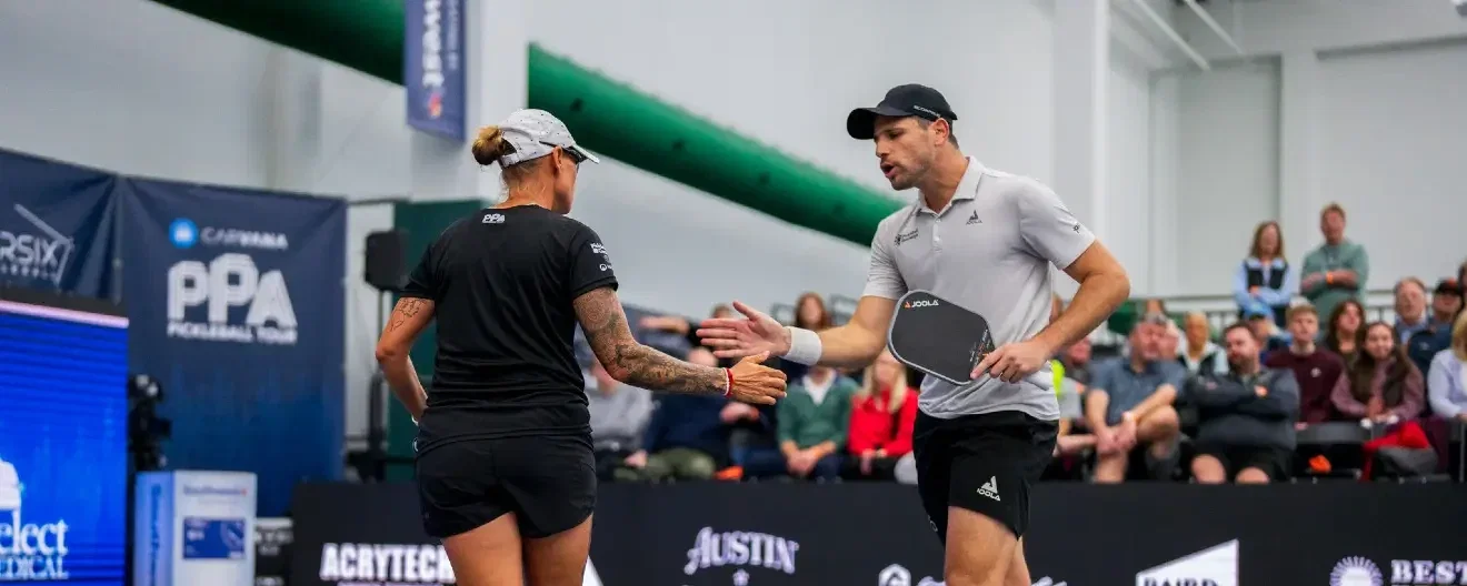 Tina Pisnik and Dekel Bar celebrate a pickleball point.