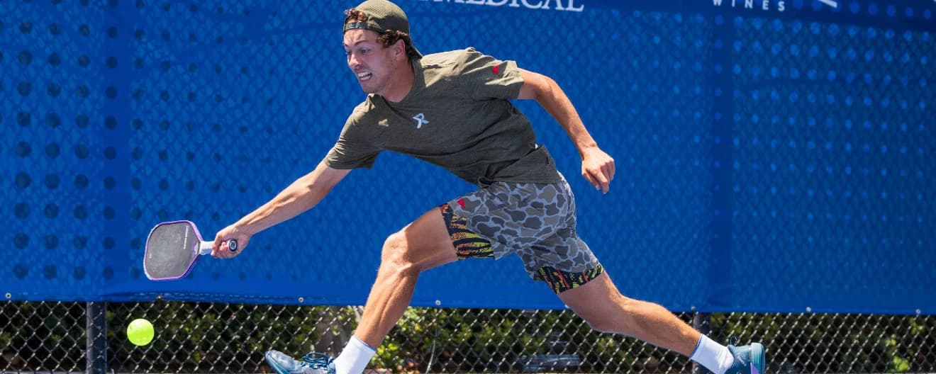 Connor Garnett hitting a forehand on the run.