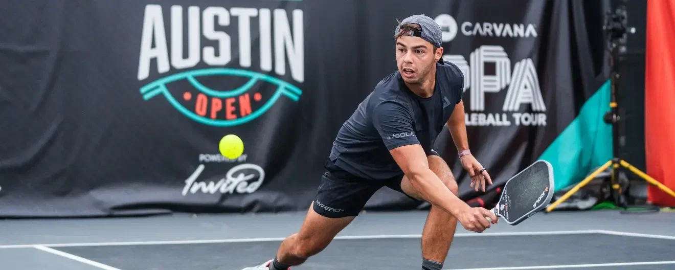 Ben Johns hits a backhand in pickleball.