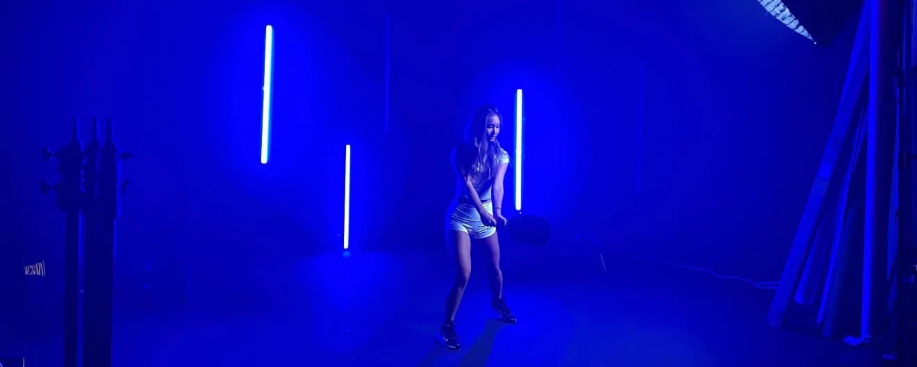 Alix Troung at a studio with blue lighting illuminating her silhouette.